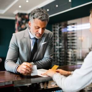 Mature businessman at hotel reception.